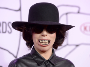 Gaga Pops some Art on her Chompers: The story behind Lady Gaga’s creepy, creepy teeth