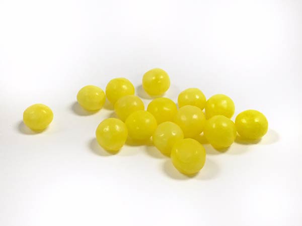 Lemonhead, a lemon-flavored candy that combines a sweet coating, soft sour shell, and a hard candy core