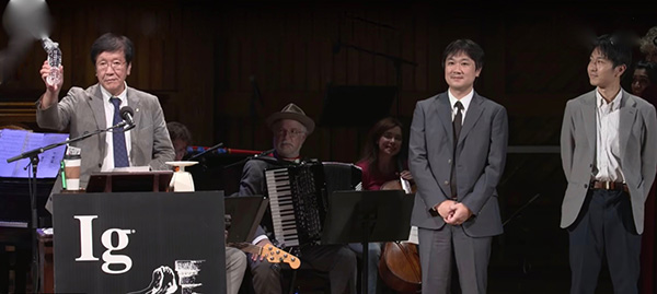 Professor Watanabe and two of his sons accepting the Ig Nobel Award. (From YouTube video.)
